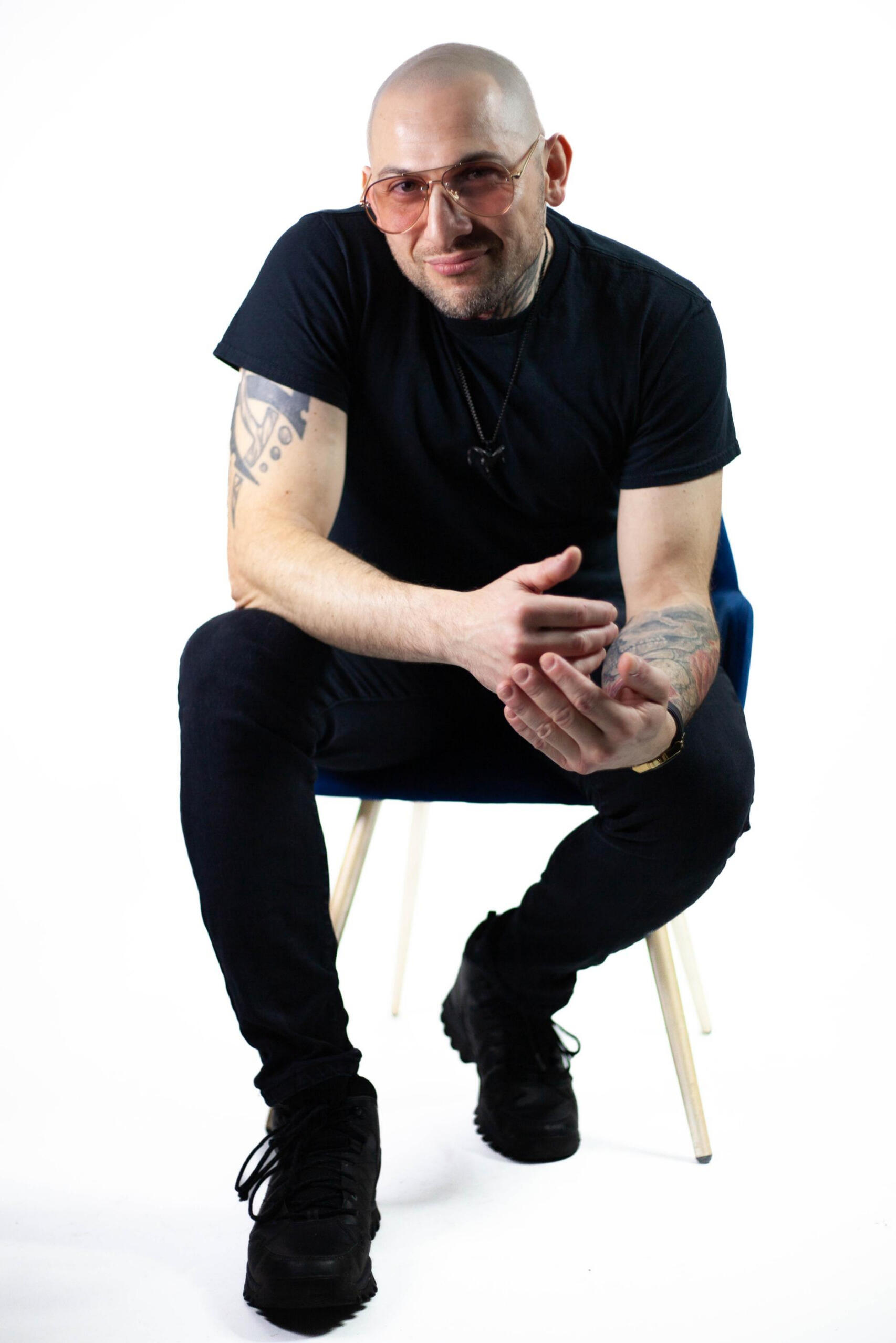 Nader Eid, speaker and story coach, seated and looking at the viewer, founder and host of Threshold live storytelling events